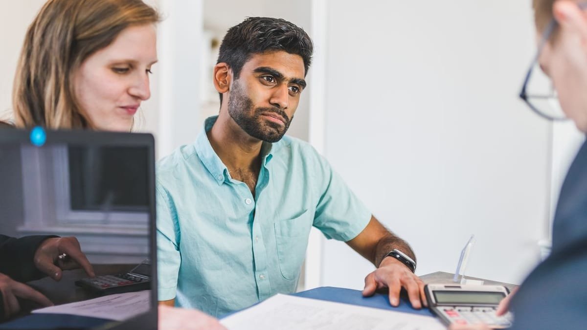 Agent consulting with clients at a desk